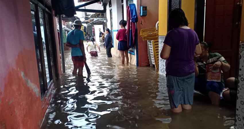 Warga Lingkungan Kampung Ujung, Kelurahan Kepatihan mengamankan perabotan rumah tangga dari kepungan banjir, Senin (09/03/2020) sore. (ras)